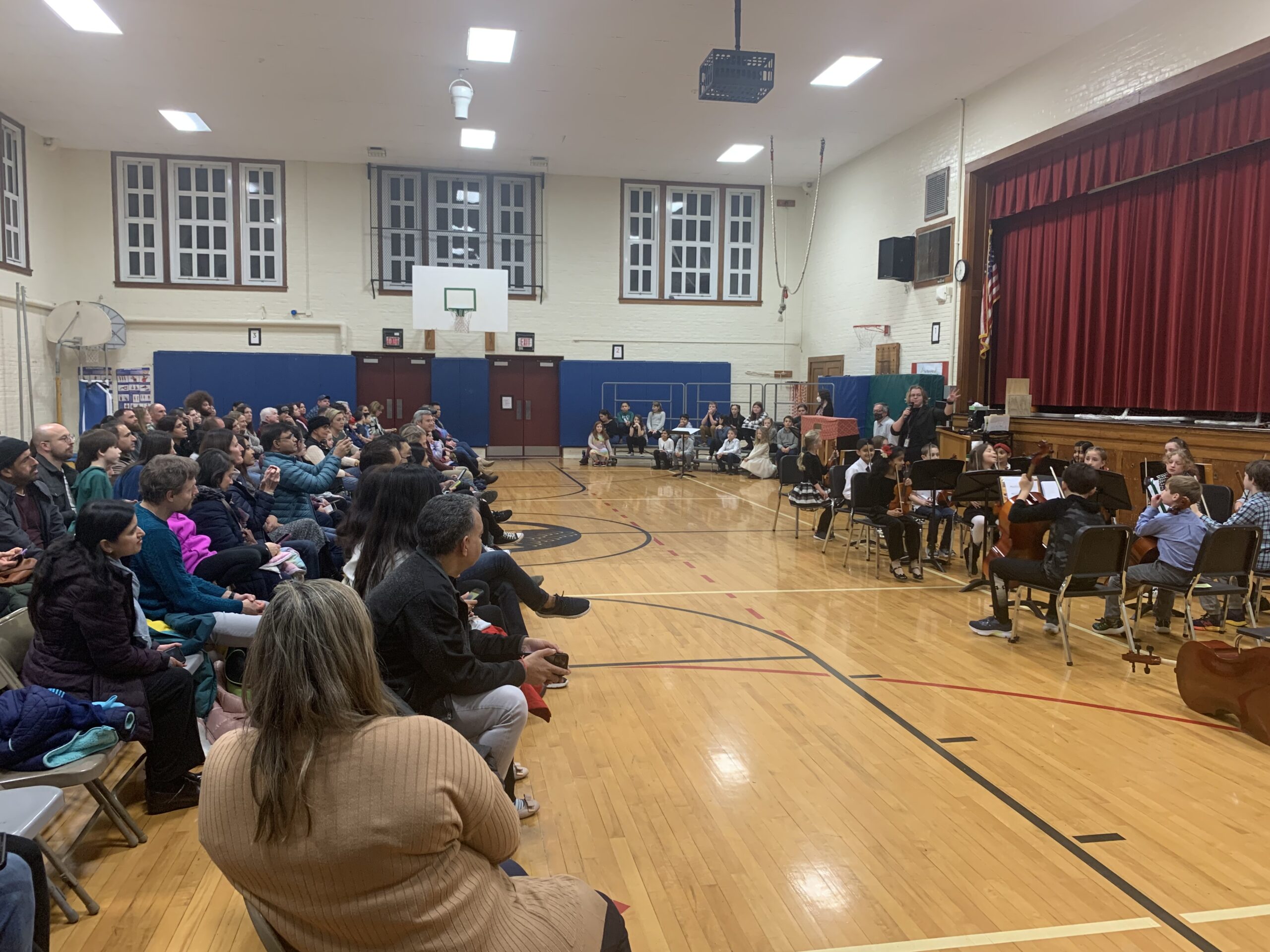 student orchestra and choir in school gym