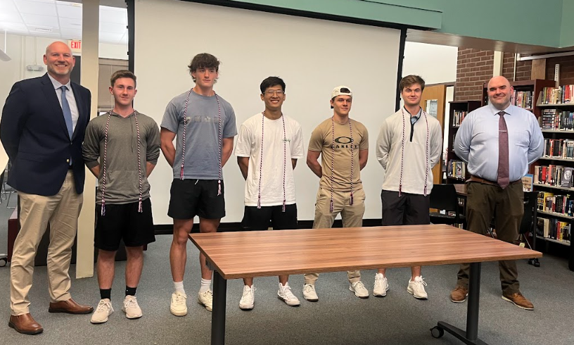 Students standing with military cords around necks